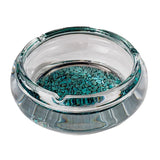 Clear round glass ashtray with turquoise base on white background