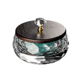 Side view of round glass ashtray with wooden lid