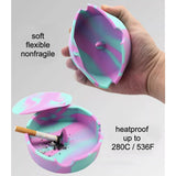 Hand bending marbled silicone ashtray to show soft flexible material