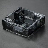 Gray square glass ashtray on dark background