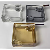 Top view of clear, amber, and gray square glass ashtrays
