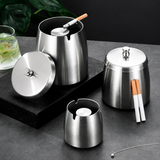 Stainless steel lidded ashtrays in multiple sizes on a tabletop