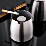 Open stainless steel ashtray with cigarette rest and center snuffer plate