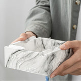 Person holding square ceramic marble pattern ashtray with sturdy polished body