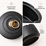 Black ceramic ashtray details showing metal knob cigarette rest and pottery texture
