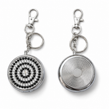 Portable metal ashtray keychain showing front rhinestone design and plain back