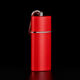 Red portable metal pocket ashtray with lid and keychain clip on black background