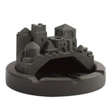 Castle-style cement ashtray with black round base