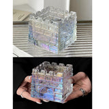 Iridescent geometric glass ashtray held in hand