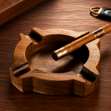 Wooden cigar ashtray with cigar resting on carved groove