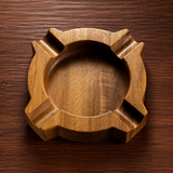 Round Walnut Brown wooden cigar ashtray with 4 cigar rests on wooden table