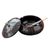 Ceramic ashtray with lid in Black Plum Glaze finish, shown open with cigarette rest