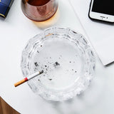 Top view of clear cut glass ashtray with cigarette, stylish crystal ashtray for home or office