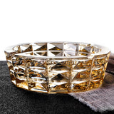 Amber crystal glass ashtray on dark fabric, elegant heavy ashtray for indoor smoking decor