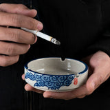 Blue clouds ceramic ashtray with illustrated side pattern, speckled glaze, and three cigarette rests
