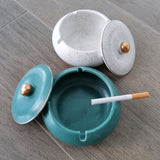 Open white and teal ceramic ashtrays showing deep bowls, matching lids and cigarette rests