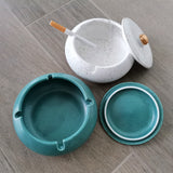 Teal and white ceramic ashtrays open with matching lids showing their bowl capacity