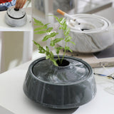 Dark gray lidded ceramic ashtray used as a decorative tabletop piece