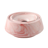 Pink marble-style ceramic ashtray with lid on white background
