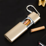 Gold portable pocket ashtray with lid and clip beside cigarette on black background