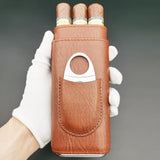 Hand holding brown leather cigar case with three cigars
