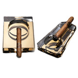 Two gold color crystal glass cigar ashtrays on white background