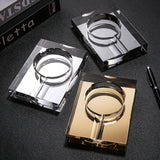 Silver Black and gold crystal glass cigar ashtrays with single cigar rests displayed together