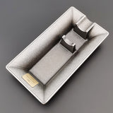 Silver rectangular metal cigar ashtray angled view on dark background