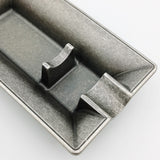 Close-up of rectangular metal cigar ashtray with raised cigar support