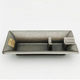 Side view of vintage bronze rectangular metal cigar ashtray