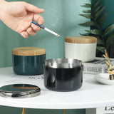 Nordic lidded ashtrays in teal, white, and black for indoor and outdoor smoking areas