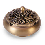 Palm-sized copper ashtray with carved lid in retro style on white background