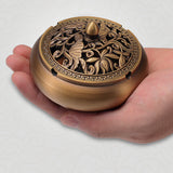 Palm-sized copper ashtray held in both hands for size reference