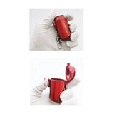 Red mini pocket ashtray held in hand, compact metal keychain ashtray with secure lid