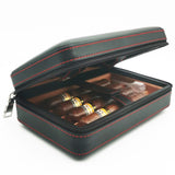 Black leather cigar humidor case partially opened on dark background