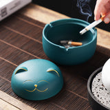 Happy cat ashtray with removable lid and cigarette resting inside