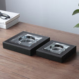 small and large glass ashtray with leather case side by side